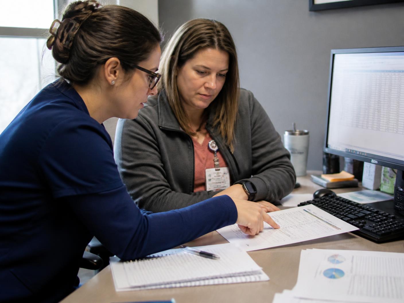 Billing specialists reviewing a small practice's claims and collections reports